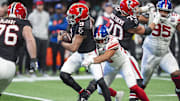 Dec 22, 2024; Atlanta, Georgia, USA; New York Giants linebacker Darius Muasau (53) sacks Atlanta Falcons quarterback Michael Penix Jr. (9) during the first half at Mercedes-Benz Stadium. 