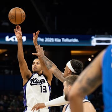 Mar 29, 2025; Orlando, Florida, USA; Sacramento Kings forward Keegan Murray (13) shoots the ball over Orlando Magic forward Paolo Banchero (5) in the first quarter at Kia Center. Mandatory Credit: Jeremy Reper-Imagn Images