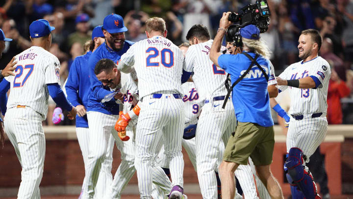 Aug 19, 2024; New York City, New York, USA; New York Mets first baseman Pete Alonso (20) rips the shirt off of New York Mets catcher Francisco Alvarez (4) for hitting a walk off winning home run against the Baltimore Orioles during the ninth inning at Citi Field. Mandatory Credit: Gregory Fisher-USA TODAY Sports