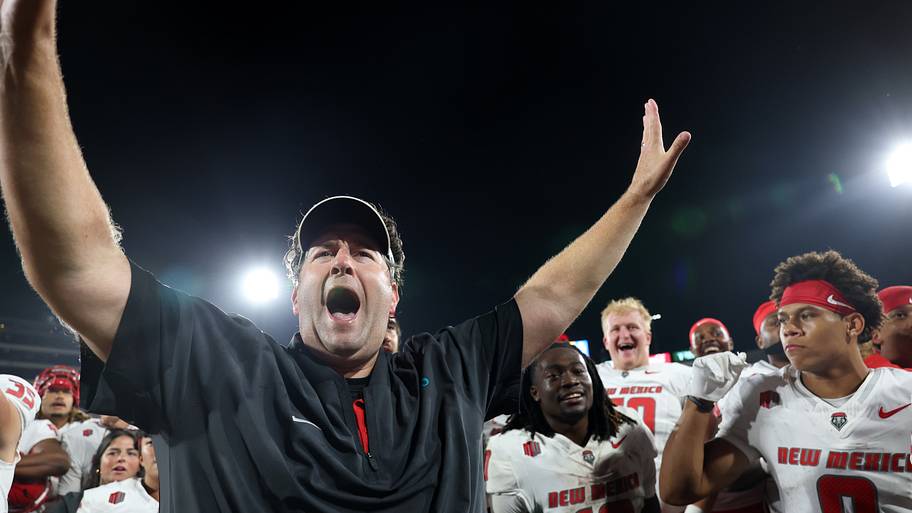 New Mexico Lobos head coach Jason Eck celebrates with his players after defeating the UCLA Bruins.
