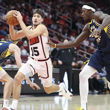 Nov 20, 2024; Houston, Texas, USA; Houston Rockets guard Reed Sheppard (15) attempts to drive with the ball past Indiana Pacers forward Johnny Furphy (12) during the second quarter at Toyota Center. Mandatory Credit: Troy Taormina-Imagn Images