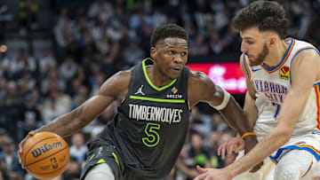 Feb 23, 2025; Minneapolis, Minnesota, USA; Minnesota Timberwolves guard Anthony Edwards (5) dribbles the ball past Oklahoma City Thunder forward Chet Holmgren (7) in the second half at Target Center. Mandatory Credit: Jesse Johnson-Imagn Images