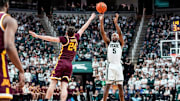 Michigan State guard Tre Holloman (5) makes a jump shot against Minnesota guard Brennan Rigsby (24) during the second half at Breslin Center in East Lansing on Tuesday, Jan. 28, 2025.