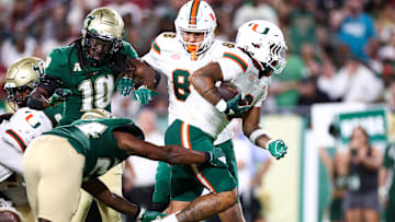 Sep 21, 2024; Tampa, Florida, USA; Miami Hurricanes running back Damien Martinez (6) score a touchdown against the South Florida Bulls in the third quarter at Raymond James Stadium. Mandatory Credit: Nathan Ray Seebeck-Imagn Images