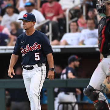 Jun 18, 2022; Omaha, NE, USA;  Ole Miss Rebels head coach Mike Bianco walks to the mound in the eighth inning against the Auburn Tigers at Charles Schwab Field. Mandatory Credit: Steven Branscombe-Imagn Images