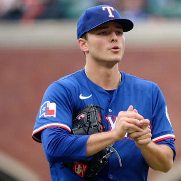 Apr 27, 2025; San Francisco, California, USA; Texas Rangers starting pitcher Jack Leiter (35) rubs up a new baseball against the San Francisco Giants during the third inning at Oracle Park.