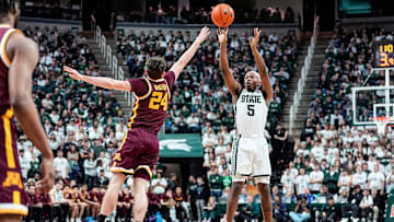 Michigan State guard Tre Holloman (5) makes a jump shot against Minnesota guard Brennan Rigsby (24) during the second half at Breslin Center in East Lansing on Tuesday, Jan. 28, 2025.