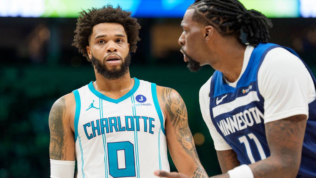 Apr 5, 2026; Minneapolis, Minnesota, USA; Charlotte Hornets forward Miles Bridges (0) and Minnesota Timberwolves center Naz Reid (11) during a break in the second quarter at Target Center. Mandatory Credit: Matt Blewett-Imagn Images