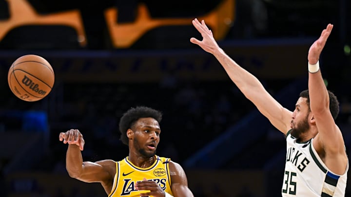 Bronny James passes while being guarded by the Bucks' Pete Nance. Bronny James passes while being guarded by the Bucks' Pete Nance.