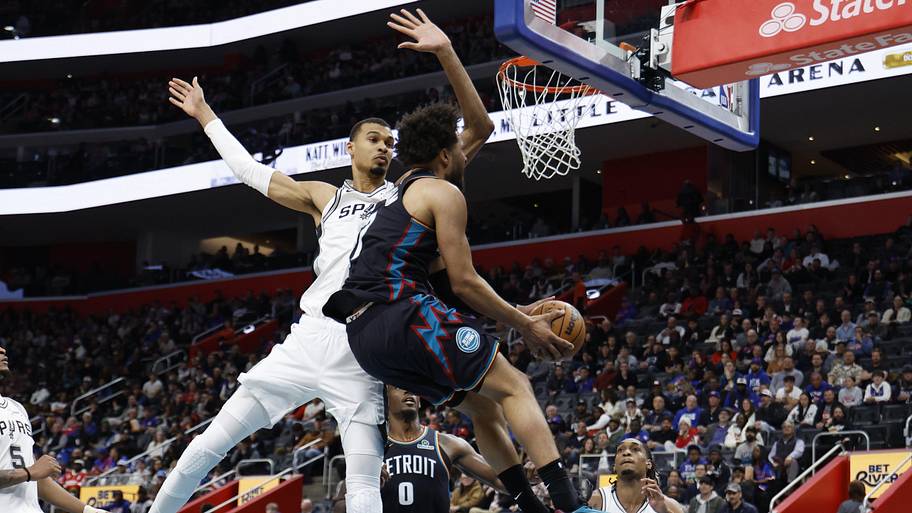 Detroit Pistons guard Cade Cunningham is fouled by San Antonio Spurs forward Victor Wembanyama.