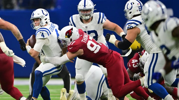 Aug 17, 2024; Indianapolis, Indiana, USA; Indianapolis Colts quarterback Sam Ehlinger (4) is sacked by Arizona Cardinals linebacker Cameron Thomas (97) during the second quarter at Lucas Oil Stadium. Mandatory Credit: Marc Lebryk-USA TODAY Sports