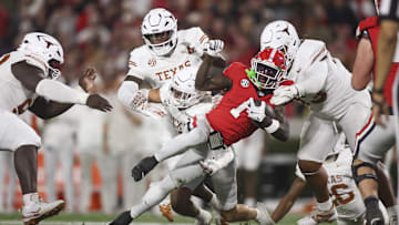 Georgia Bulldogs wide receiver Zachariah Branch (1) is tackle by Texas Longhorns defensive back Michael Taaffe (16) and defensive tackle Hero Kanu (93) in the first half at Sanford Stadium.