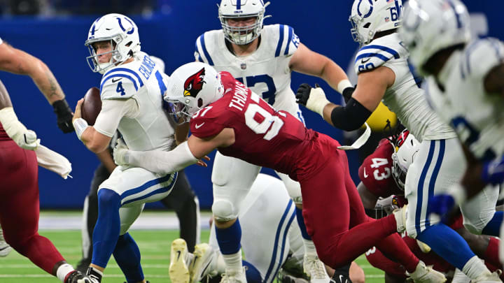 Aug 17, 2024; Indianapolis, Indiana, USA; Indianapolis Colts quarterback Sam Ehlinger (4) is sacked by Arizona Cardinals linebacker Cameron Thomas (97) during the second quarter at Lucas Oil Stadium. Mandatory Credit: Marc Lebryk-USA TODAY Sports