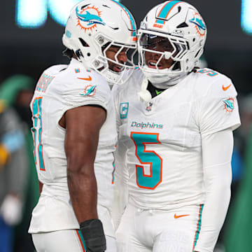 Jan 5, 2025; East Rutherford, New Jersey, USA; Miami Dolphins cornerback Jalen Ramsey (5) celebrates a defensive stop with linebacker Tyrel Dodson (11) during the first quarteragainst the New York Jets at MetLife Stadium. Mandatory Credit: Vincent Carchietta-Imagn Images
