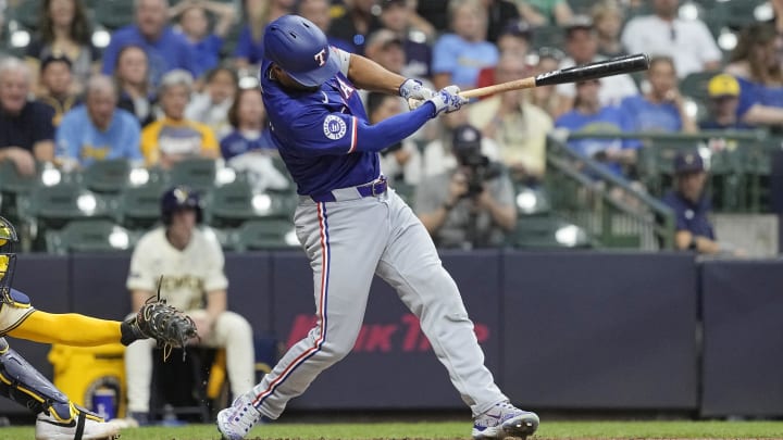 Jun 24, 2024; Milwaukee, Wisconsin, USA;  Texas Rangers second baseman Marcus Semien (2) hits a single to drive in a run during the fifth inning against the Milwaukee Brewers at American Family Field. 
