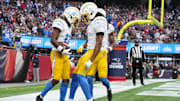 Dec 28, 2024; Foxborough, Massachusetts, USA; Los Angeles Chargers wide receiver Derius Davis (12) celebrates with wide receiver Quertin Johnston (1) after scoring a touchdown against the New England Patriots during the first half at Gillette Stadium. Mandatory Credit: Gregory Fisher-Imagn Images