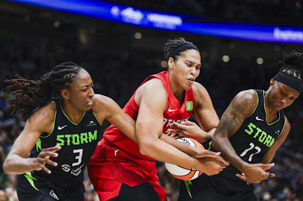 Atlanta Dream forward Brionna Jones collects an offensive rebound against Seattle Storm forward Nneka Ogwumike. 