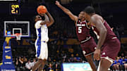 Dec 2, 2025; Pittsburgh, Pennsylvania, USA;  Pittsburgh Panthers guard Damarco Minor (7) shoots a three point basket against Texas A&M Aggies guard Jacari Lane (5) during the first half at the Petersen Events Center. Mandatory Credit: Charles LeClaire-Imagn Images