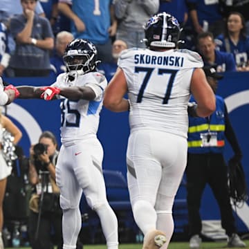 Oct 26, 2025; Indianapolis, Indiana, USA;  Tennessee Titans tight end Gunnar Helm (84) celebrates with Tennessee Titans tight end Chig Okonkwo (85) and Tennessee Titans tight end David Martin-Robinson (88) after scoring a touchdown during the second quarter against the Indianapolis Colts at Lucas Oil Stadium. Mandatory Credit: Robert Goddin-Imagn Images