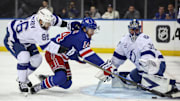 Nov 29, 2025; New York, New York, USA;  Tampa Bay Lightning goaltender Jonas Johansson (31) defends the net as right wing Nikita Kucherov (86) and New York Rangers right wing Taylor Raddysh (14) battle for control of the puck in the second period at Madison Square Garden. Mandatory Credit: Wendell Cruz-Imagn Images