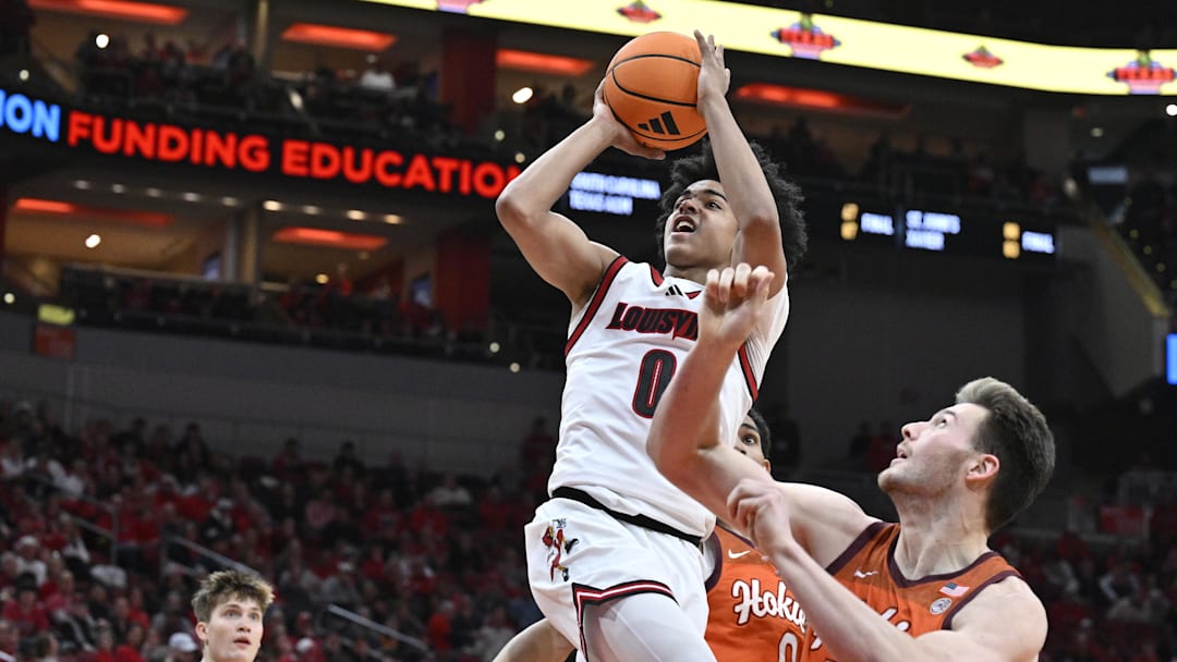 Jan 24, 2026; Louisville, Kentucky, USA;  Louisville Cardinals guard Mikel Brown Jr. (0) shoots against Virginia Tech Hokies center Christian Gurdak (32) during the second half at KFC Yum! Center. Louisville defeated Virginia Tech 85-71. Mandatory Credit: Jamie Rhodes-Imagn Images
