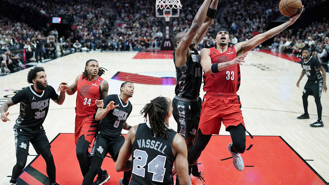 Apr 6, 2025; Portland, Oregon, USA; Portland Trail Blazers forward Toumani Camara (33) shoots against San Antonio Spurs center Bismack Biyombo (18) during the second half at Moda Center. Mandatory Credit: Soobum Im-Imagn Images