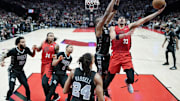 Apr 6, 2025; Portland, Oregon, USA; Portland Trail Blazers forward Toumani Camara (33) shoots against San Antonio Spurs center Bismack Biyombo (18) during the second half at Moda Center. Mandatory Credit: Soobum Im-Imagn Images