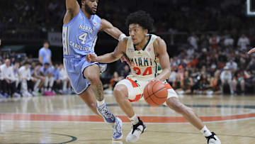 Feb 10, 2024; Coral Gables, Florida, USA; Miami Hurricanes guard Nijel Pack (24) drives to the basket past North Carolina Tar Heels guard RJ Davis (4) during the second half at Watsco Center. Mandatory Credit: Sam Navarro-Imagn Images