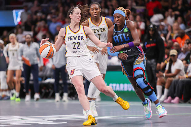 Indiana Fever guard Caitlin Clark (22) is fouled by Atlanta Dream guard Rhyne Howard (10)
