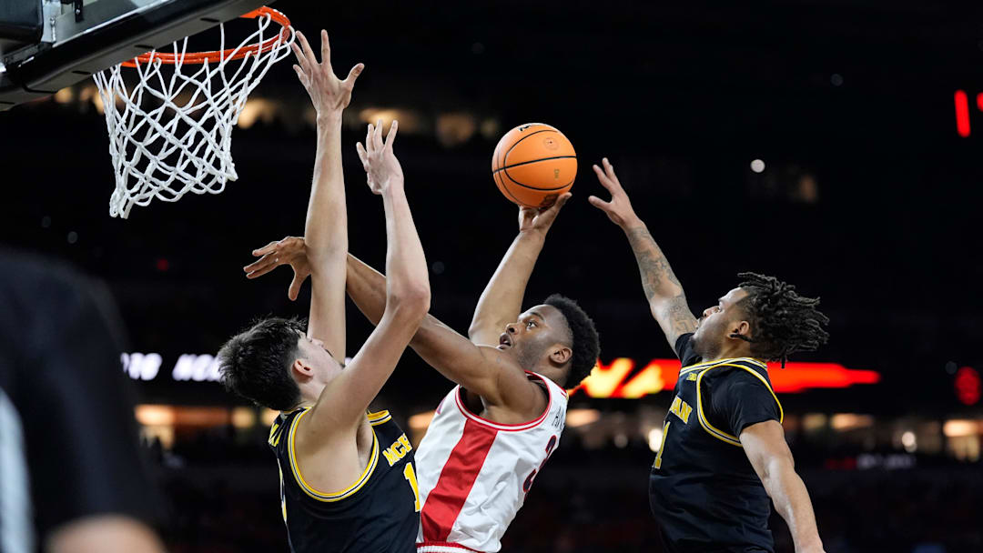Michigan center Aday Mara and Michigan guard Roddy Gayle Jr. guard Arizona forward Tobe Awaka 