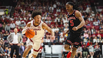Feb 1, 2025; Tuscaloosa, Alabama, USA; Alabama Crimson Tide guard Mark Sears (1) drives the ball against Georgia Bulldogs guard Silas Demary Jr. (5) during the first half at Coleman Coliseum. Mandatory Credit: Will McLelland-Imagn Images