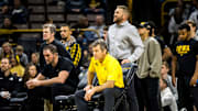Iowa associate head coach Terry Brands, left, assistant coach Bobby Telford, head coach Tom Brands (yellow) and assistant coach Ryan Morningstar (standing) watch during NCAA Big Ten Conference men's wrestling dual against Minnesota, Monday, Jan. 15, 2024, at Carver-Hawkeye Arena in Iowa City, Iowa.