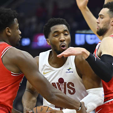 Jan 15, 2024; Cleveland, Ohio, USA; Cleveland Cavaliers guard Donovan Mitchell (45) drives between Chicago Bulls forward Terry Taylor (32) and guard Zach LaVine (8) in the second quarter at Rocket Mortgage FieldHouse. Mandatory Credit: David Richard-Imagn Images