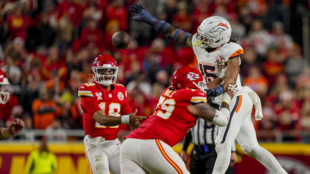 Dec 25, 2025; Kansas City, Missouri, USA; Kansas City Chiefs quarterback Chris Oladokun (19) throws against Denver Broncos linebacker Nik Bonitto (15) during the fourth quarter at GEHA Field at Arrowhead Stadium. 