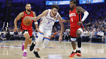 Oct 9, 2024; Oklahoma City, Oklahoma, USA; Oklahoma City Thunder forward Chet Holmgren (7) drives to the basket beside Houston Rockets guard Jalen Green (4) during the first quarter at Paycom Center. Mandatory Credit: Alonzo Adams-Imagn Images