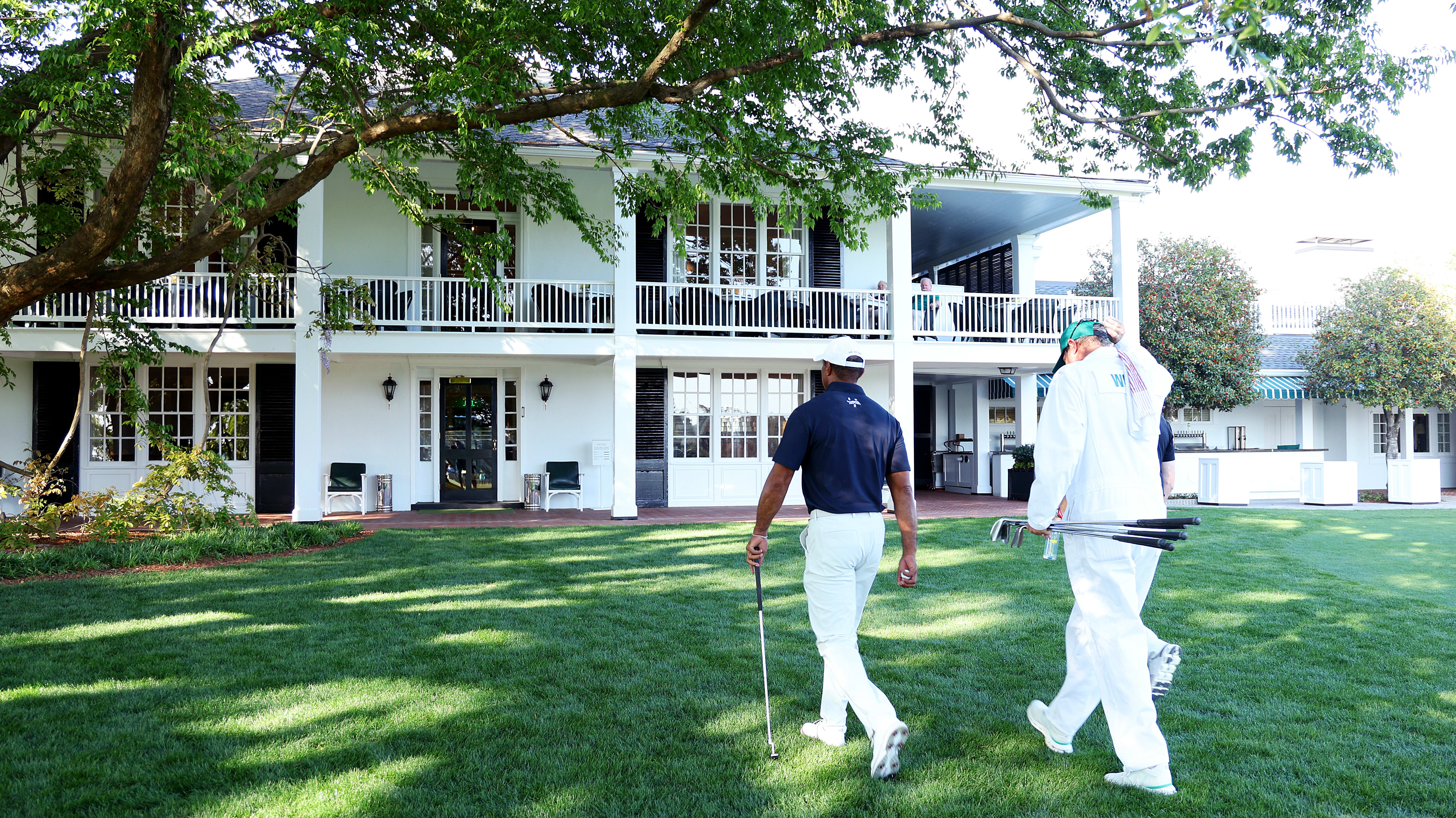 Tiger Woods walks with Rob McNamara and Lance Bennett Sunday at Augusta National.