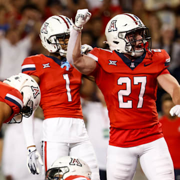 Sep 7, 2024; Tucson, Arizona, USA; Arizona Wildcats defensive back Owen Goss (27) celebrates tackle made against Northern Arizona Lumberjack during fourth quarter at Arizona Stadium.