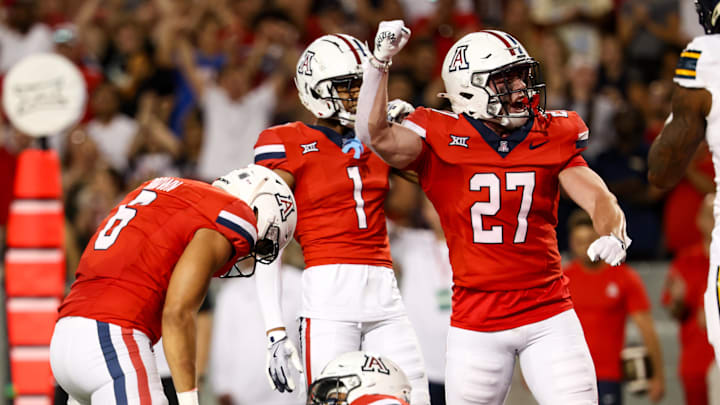 Sep 7, 2024; Tucson, Arizona, USA; Arizona Wildcats defensive back Owen Goss (27) celebrates tackle made against Northern Arizona Lumberjack during fourth quarter at Arizona Stadium.