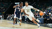 Michigan forward Yaxel Lendeborg drives while defended by Gonzaga forward Emmanuel Innocenti in the Players Era championship game.