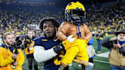 Michigan defensive end Josaiah Stewart (0) lifts the Paul Bunyan Trophy after 24-17 win over Michigan State at Michigan Stadium in Ann Arbor on Saturday, Oct. 26, 2024.