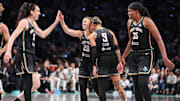 May 17, 2025; Brooklyn, New York, USA;  New York Liberty guard Sabrina Ionescu (20) celebrates with forward Breanna Stewart (30), guard Natasha Cloud (9) and center Jonquel Jones (35) after getting fouled on a made basket in the fourth quarter against the Las Vegas Aces at Barclays Center. Mandatory Credit: Wendell Cruz-Imagn Images