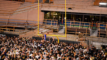Oct 5, 2024; Nashville, Tennessee, USA;  Vanderbilt Commodores fans tear down the goal post after a victory over the Alabama Crimson Tide at FirstBank Stadium. Mandatory Credit: Steve Roberts-Imagn Images