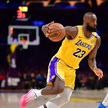 Los Angeles Lakers forward LeBron James moves to the basket against New York Knicks center Karl-Anthony Towns. Mandatory Credit: Gary A. Vasquez-Imagn Images