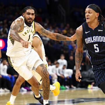 Orlando Magic forward Paolo Banchero drives to the hoop past Indiana Pacers forward Obi Toppin.