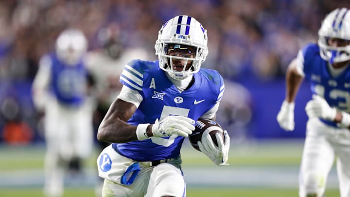 BYUs' Darius Lassiter runs with the football against Oklahoma State.