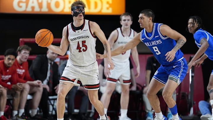Feb 3, 2026; Davidson, North Carolina, USA; Davidson Wildcats guard Roberts Blums (45) passes the ball defended by Saint Louis Billikens forward Ishan Sharma (9) during the second half at McKillop Court at John M. Belk Arena. Mandatory Credit: Jim Dedmon-Imagn Images