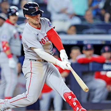 Sep 30, 2025; Bronx, New York, USA; Boston Red Sox third base Alex Bregman (2) hits an RBI double during the ninth inning against the New York Yankees during game one of the Wildcard round for the 2025 MLB playoffs at Yankee Stadium. Mandatory Credit: Brad Penner-Imagn Images