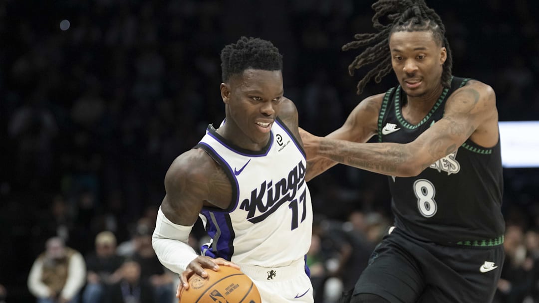 Dec 14, 2025; Minneapolis, Minnesota, USA; Sacramento Kings guard Dennis Schroder (17) dribbles the ball defended by Minnesota Timberwolves guard Bones Hyland (8) in the second half at Target Center. Mandatory Credit: Jesse Johnson-Imagn Images