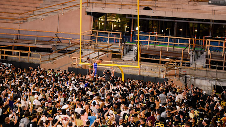 Oct 5, 2024; Nashville, Tennessee, USA;  Vanderbilt Commodores fans tear down the goal post after a victory over the Alabama Crimson Tide at FirstBank Stadium. Mandatory Credit: Steve Roberts-Imagn Images