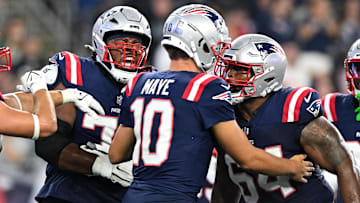Aug 15, 2024; Foxborough, Massachusetts, USA; New England Patriots quarterback Drake Maye (10) celebrates with offensive tackle Caedan Wallace (70) and guard Layden Robinson (64) after scoring a touchdown against the Philadelphia Eagles during the first half at Gillette Stadium. Mandatory Credit: Brian Fluharty-Imagn Images